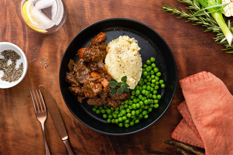 Slow cooked beef stew, buttery potato mash, green peas
